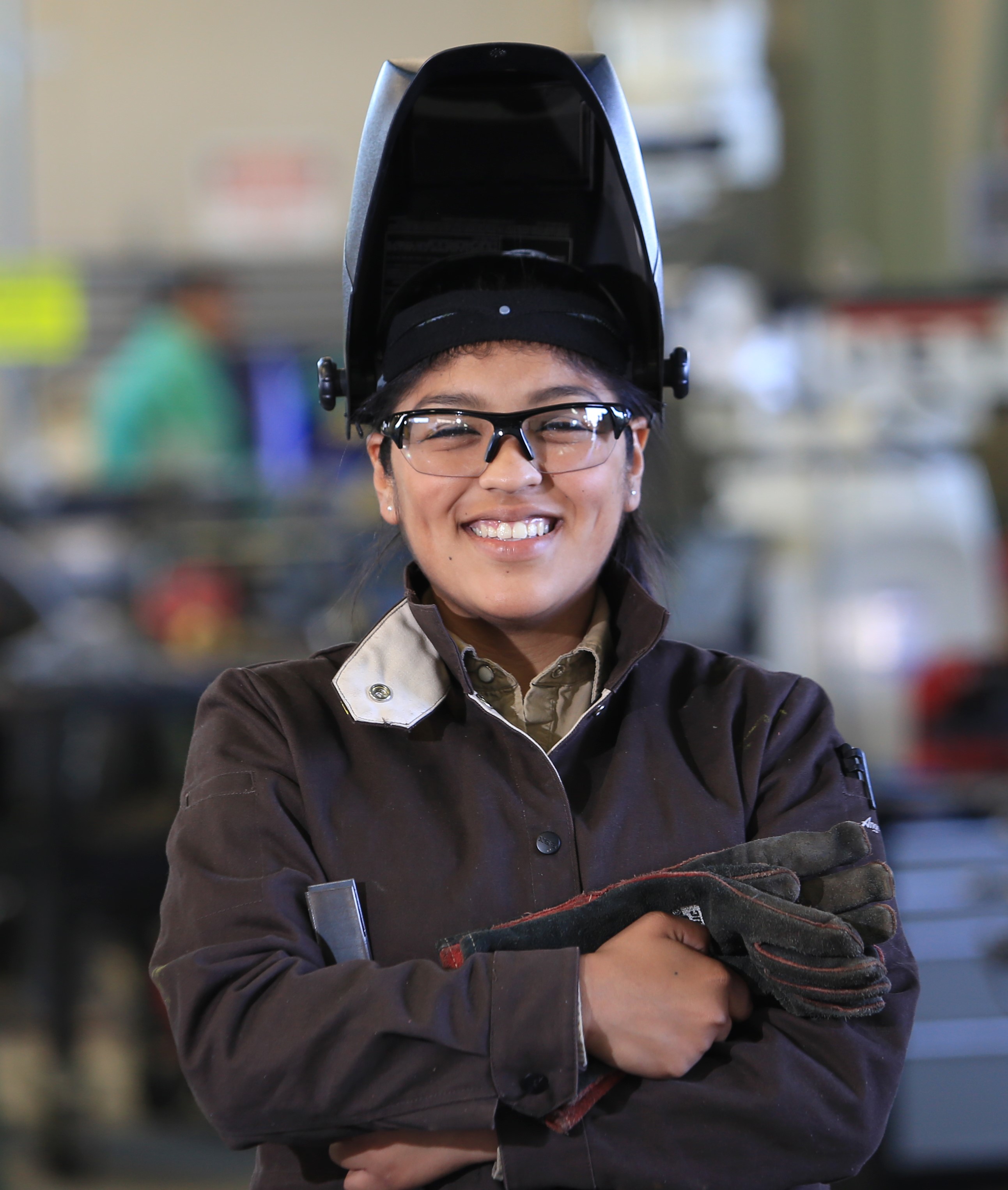Female welding student in helmet
